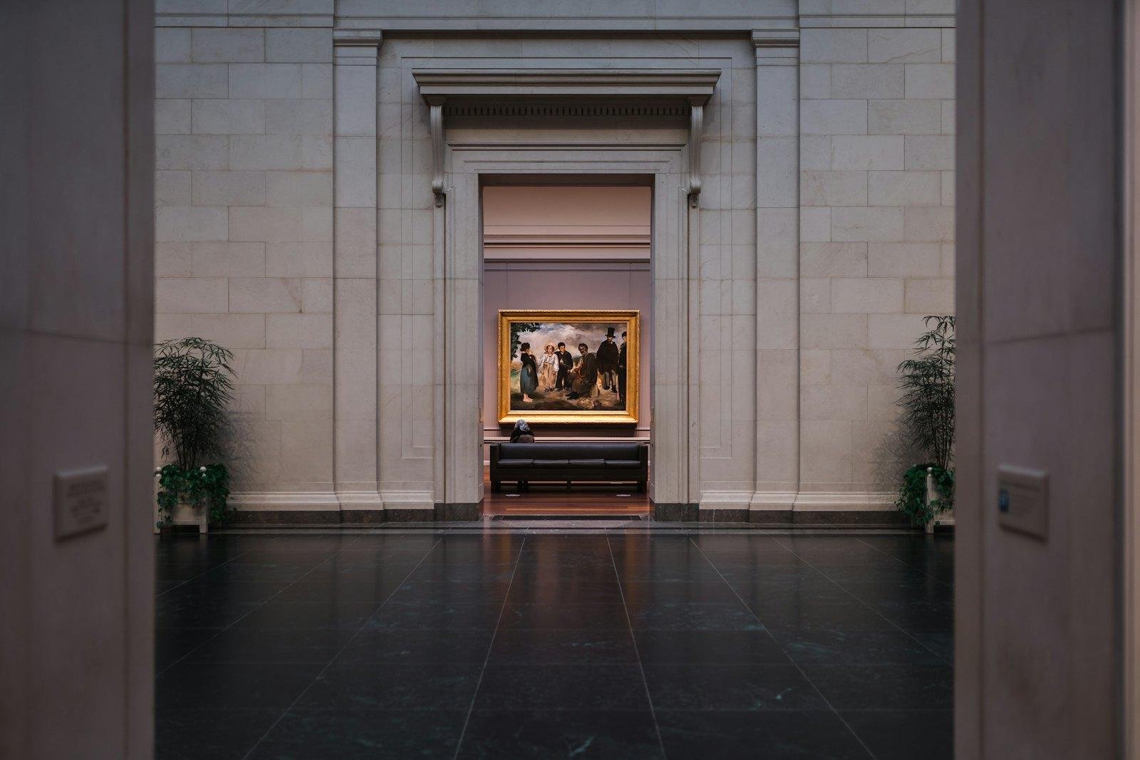 A visitor viewing a painting in the National Gallery of Art, Washington